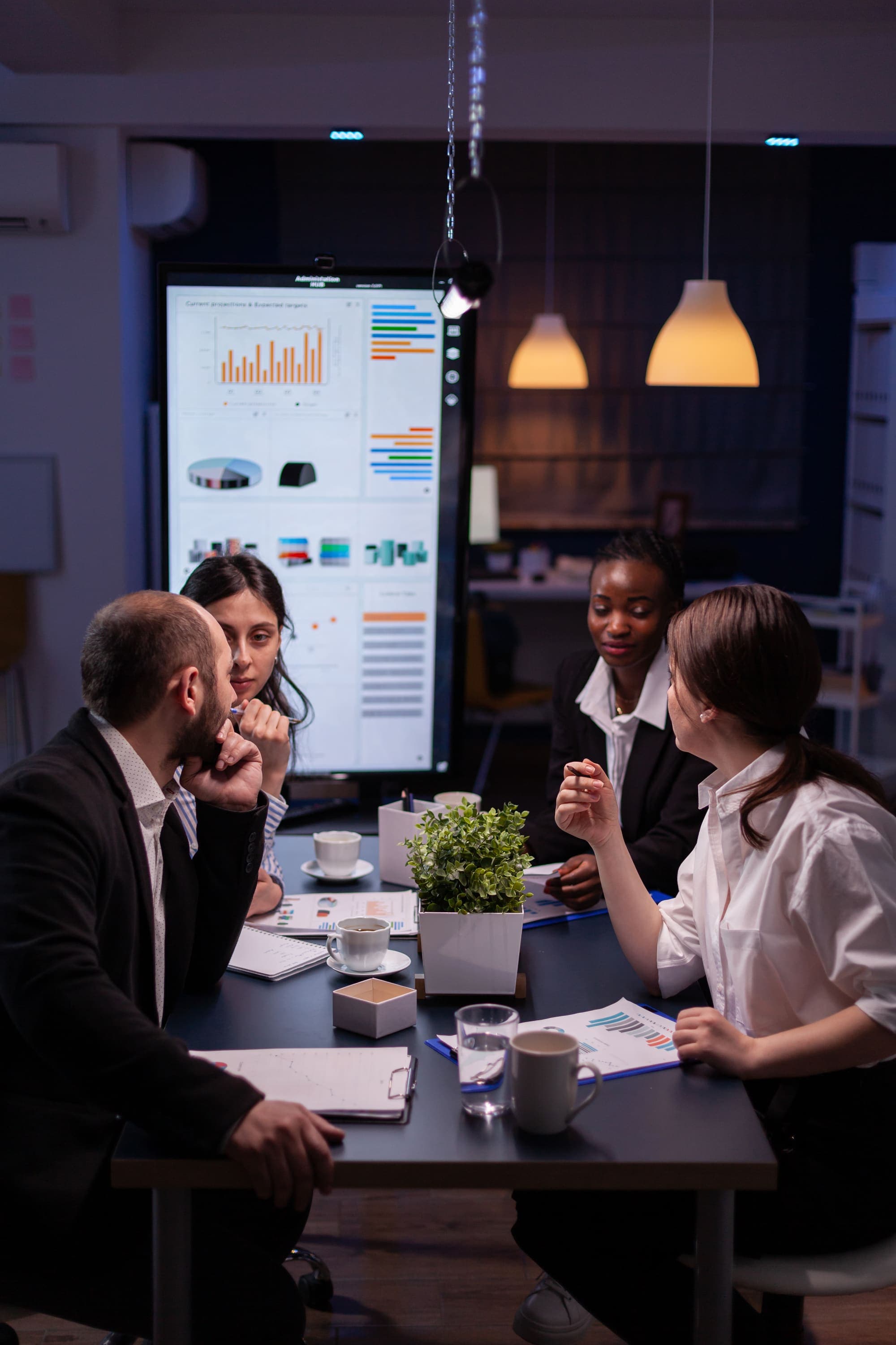 A diverse team collaborating around a shared screen