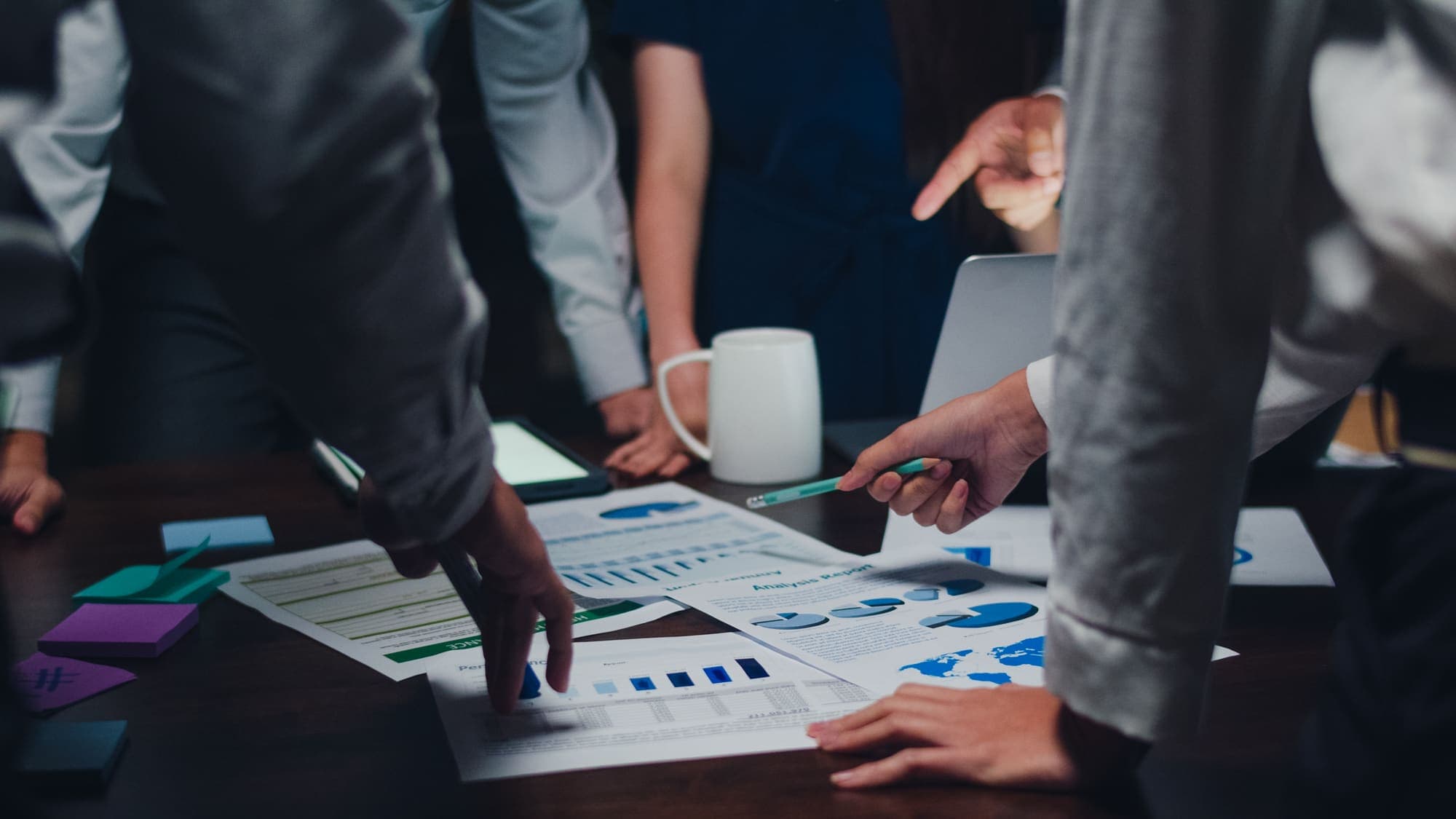 Consultants reviewing analysis reports together